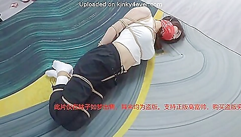 Asian brunette fucked with a dildo and a stick in a bdsm threesome