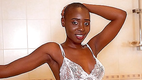 Ebony babe in a white tank top and panties goes in the bathroom