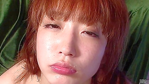 Asian redhead giving a great footjob to her boyfriend