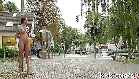 Charming redhead with big tits rides big dildo outdoors