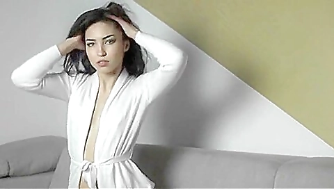 Big-ass brunette is showing off her body in her bedroom