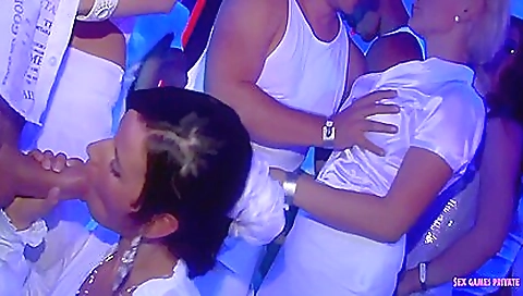 A hot brunette and blonde are having fun at a party