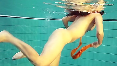 Big tits red-haired brunette is showing off her body outdoors