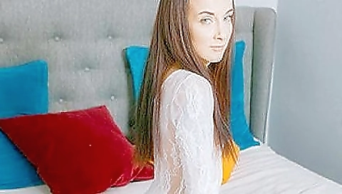 A sexy teen is getting naked and rubbing her pussy