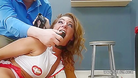 Busty redhead nurse fucked with dildo in ass and pussy